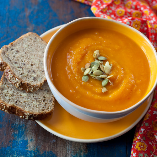 Pumpkin soup on wooden background