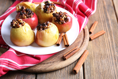 Baked apples on plate on table close up